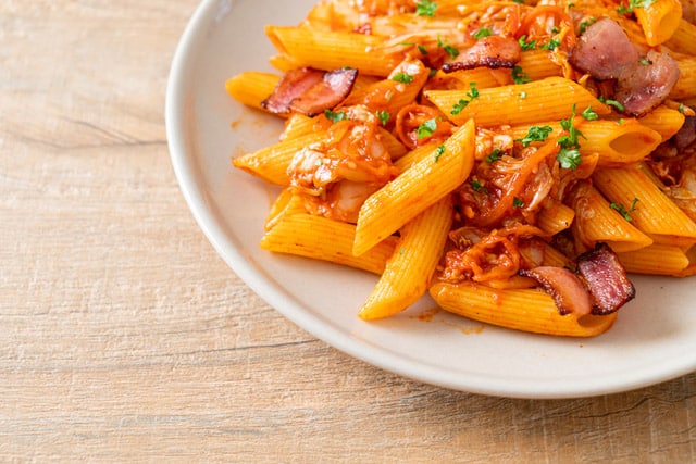 stir-fried penne pasta with kimchi and bacon