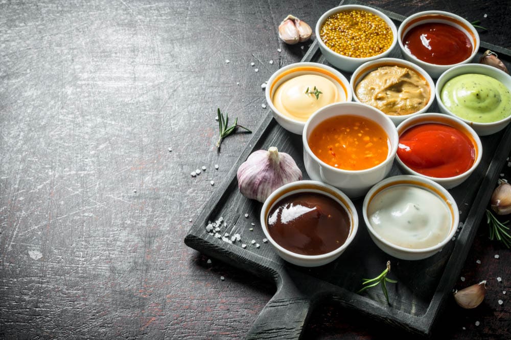 A variety of delicious sauces with slices of garlic