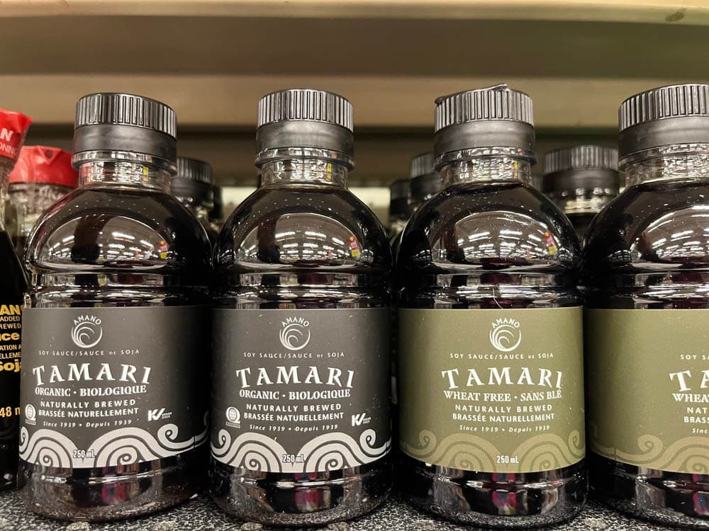 Bottles of Tamari brand organic and wheat free soy sauce on a grocery store shelf