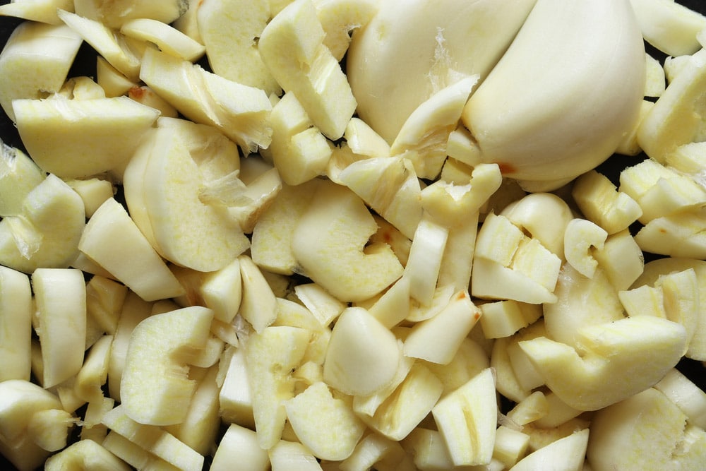 Photography of coarsely chopped garlic and peeled cloves