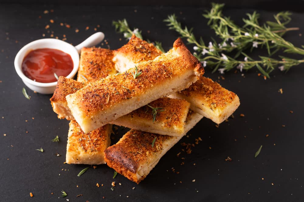 Food appetizer ideas for party concept homemade organic garlic bread stick