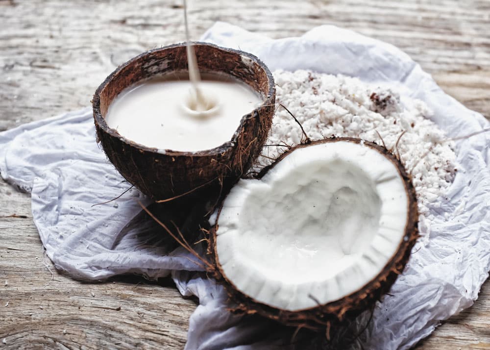 Homemade fresh hand traditional hand pressed coconut milk in a coconut bowl