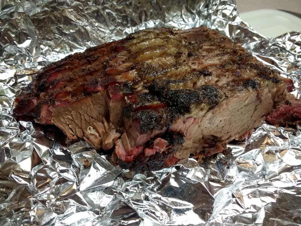 Sliced Smoked Beef Brisket laying in Tin Foil