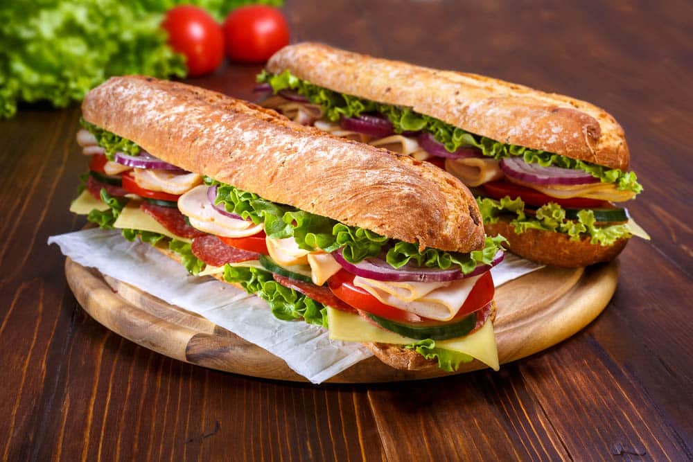 Long subway sandwiches on a dark background