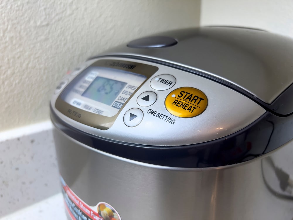 Angled view of a Zojirushi brand rice cooker inside a home