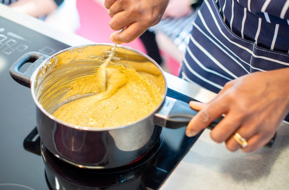 Chef cooking a roux sauce in a pan