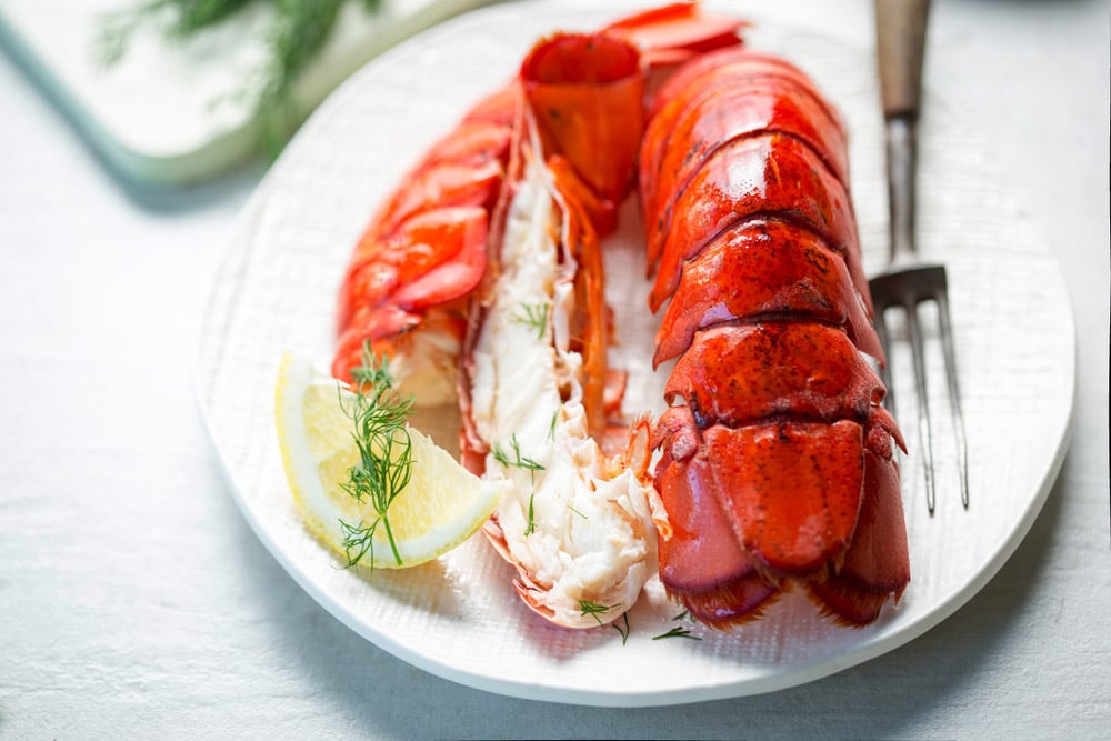 Cooked lobster tails with lemon and dill