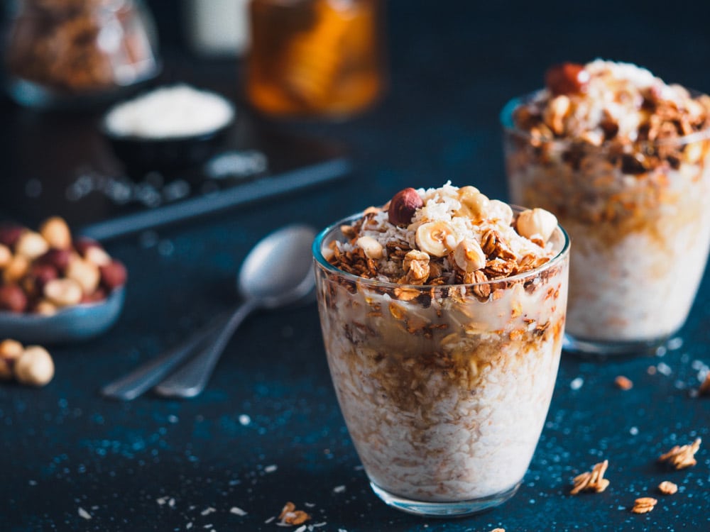 Gingerbread coconut overnight oatmeal served with granola, pecan, honey