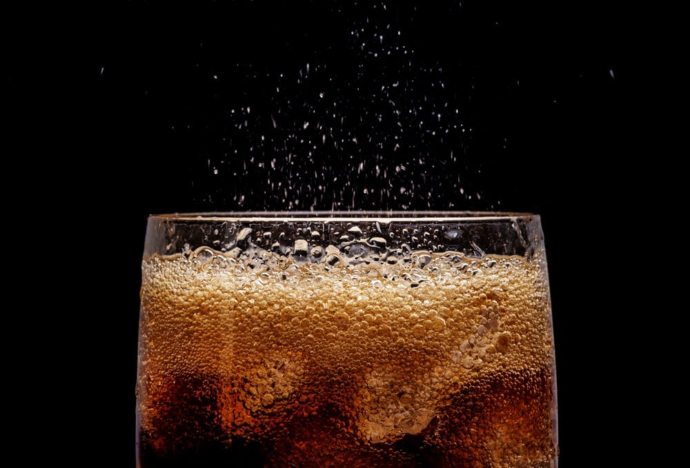 Ice cola with splashing CO bubbles