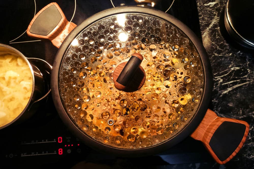 Pan on the stove with condensation on the glass lid