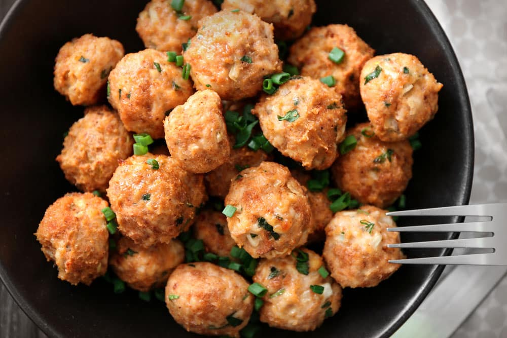 Plate with delicious turkey meatballs on table