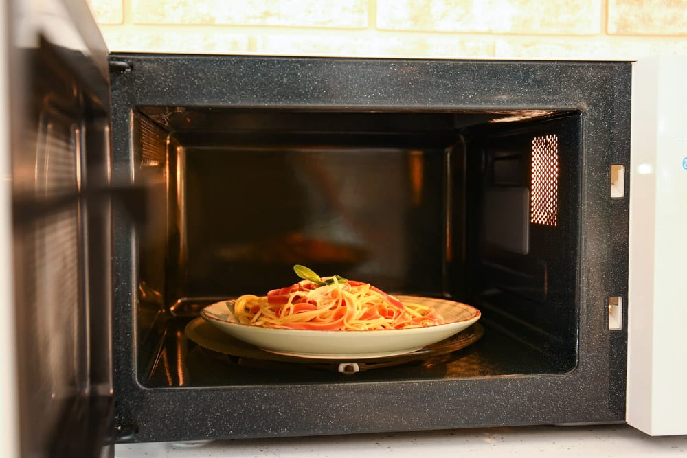 Plate with food in microwave oven