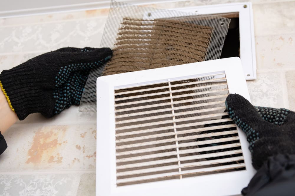 Extremely dirty and dusty white plastic ventilation air grille at home