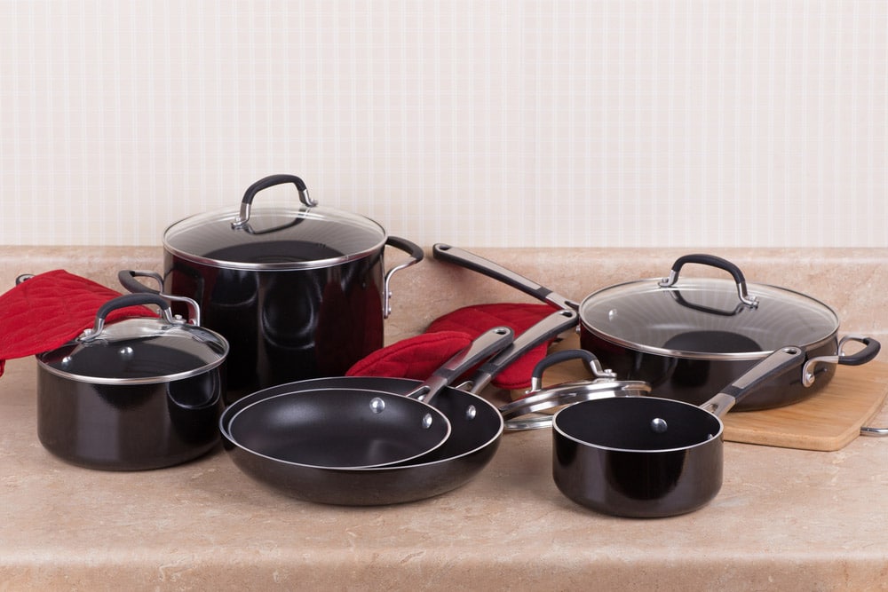 Set of new black aluminum cookware on a kitchen counter