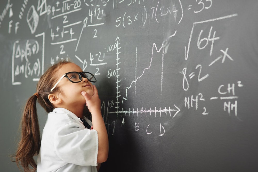 Shot of an academically gifted young girl solving a math equation