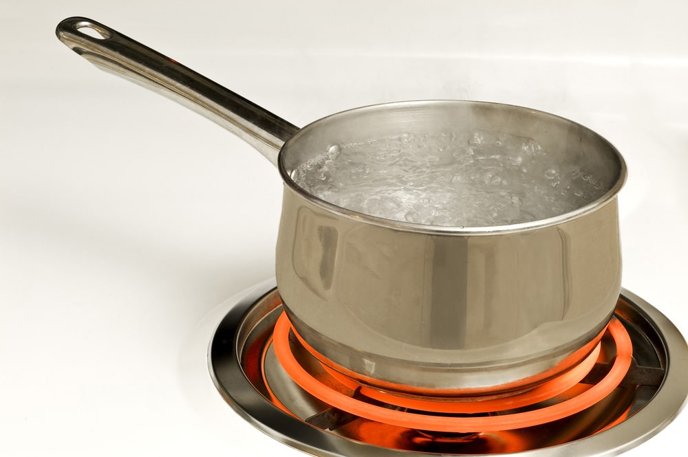 Stainless Steel Pot On Red Hot Electric Burner On Stove