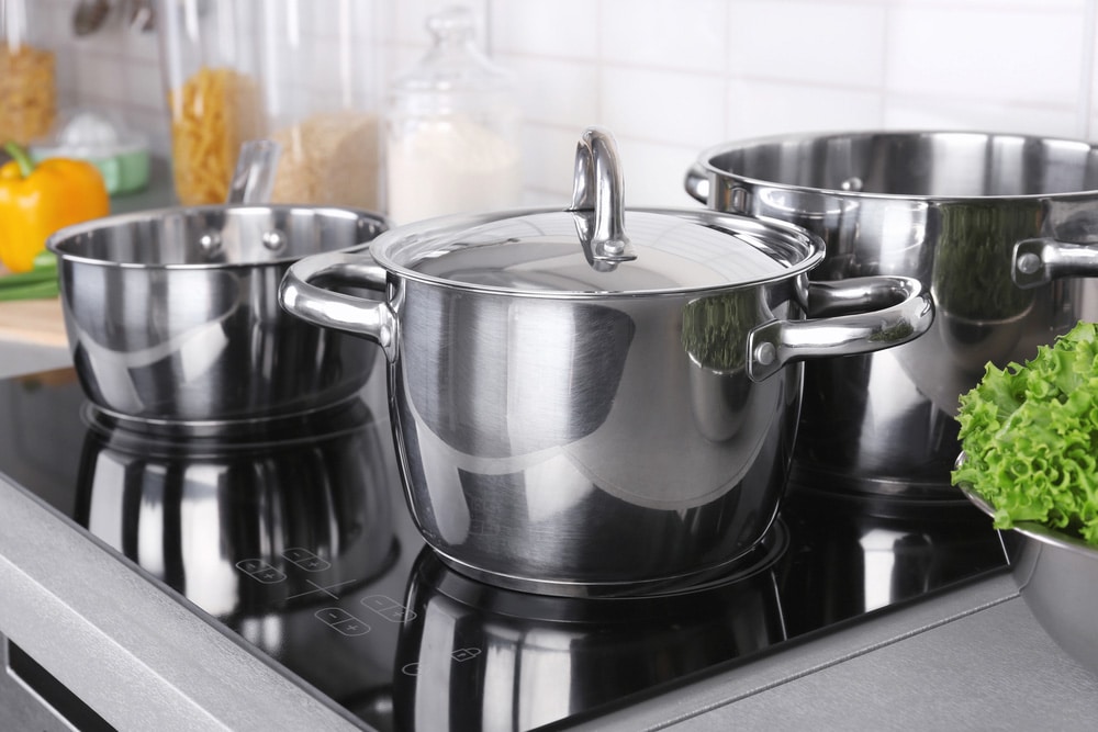 Utensils for cooking classes on electric stove in kitchen