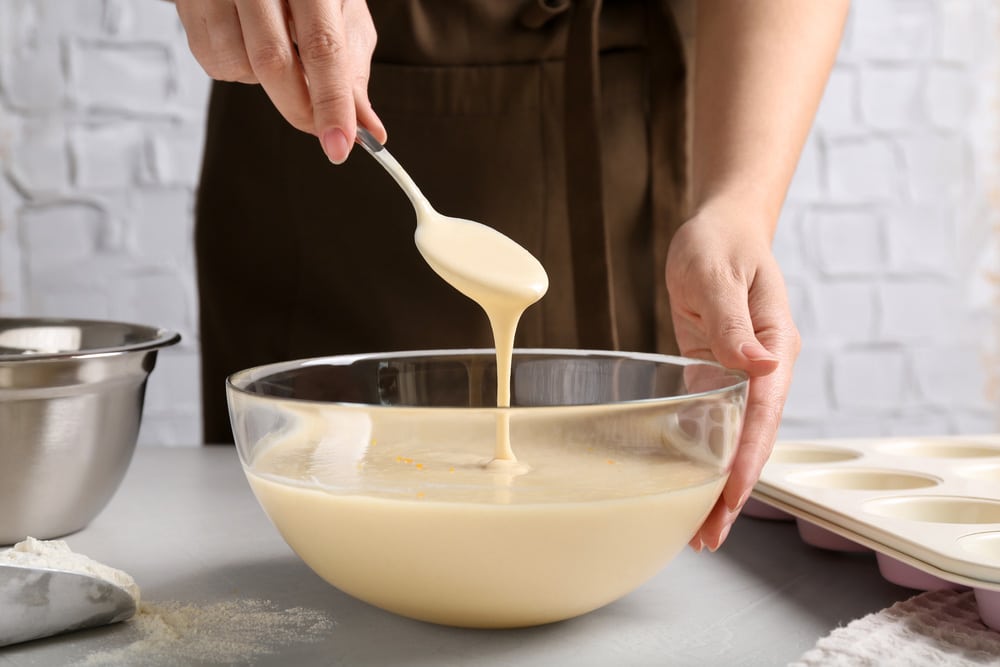 Woman making batter at light table