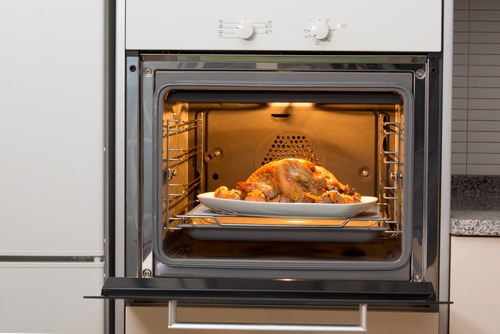 Entire chicken being cooked in oven