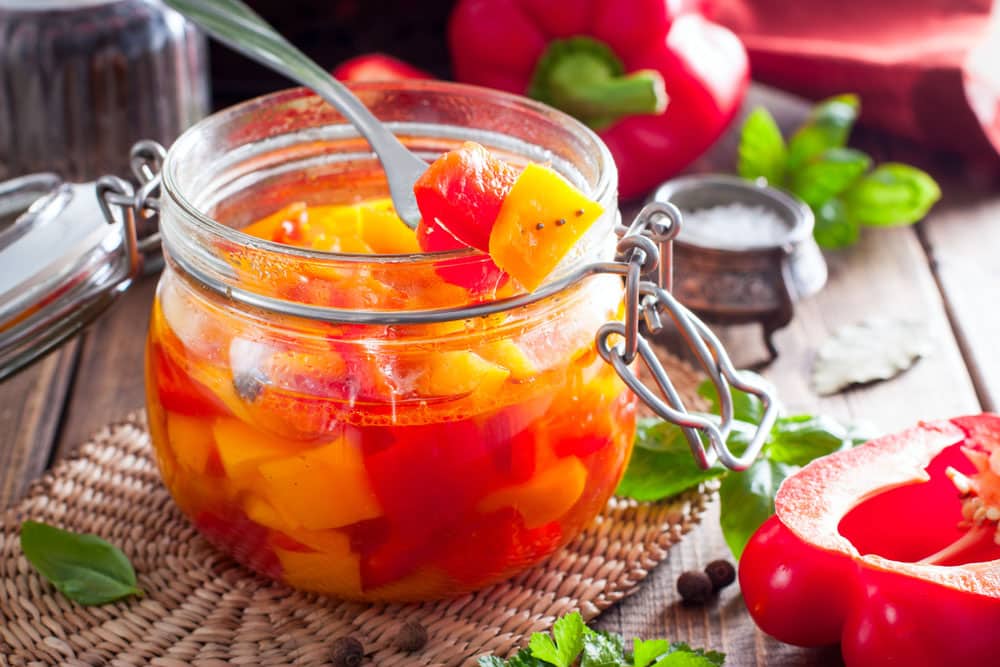 Fermented multicolored bell peppers in a glass jar