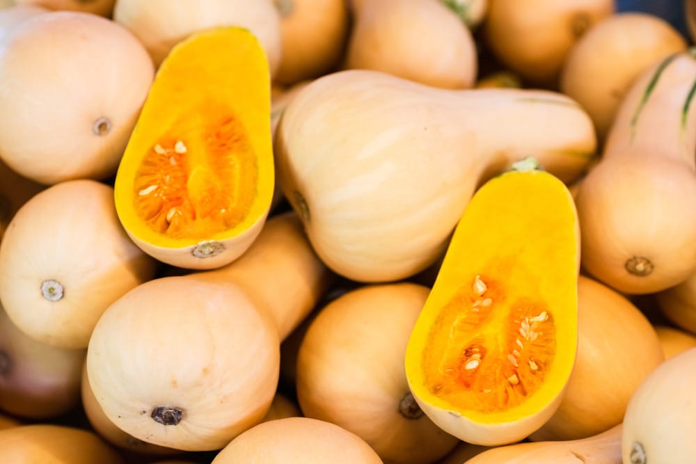 Fresh Honeynut Butternut Squash at a produce stand