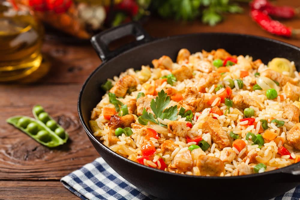 Fried rice with porchetta prepared and served in a wok