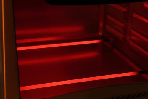 Glowing red heating elements in electric oven