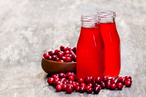 Organic cranberry juice in bottles with berries