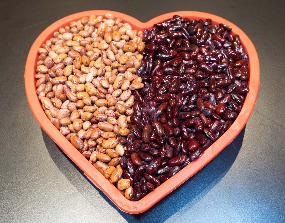 Red heart decorated with candles and kidney and red beans