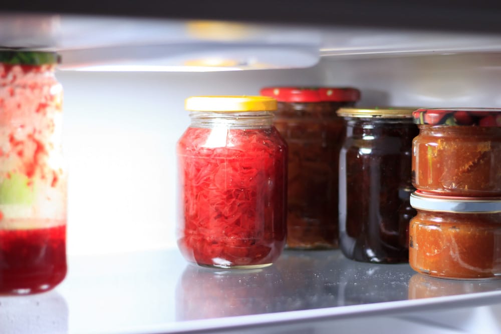 Salsa jars on the shelf in the fridge