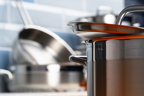 Set of aluminum cookware on kitchen counter