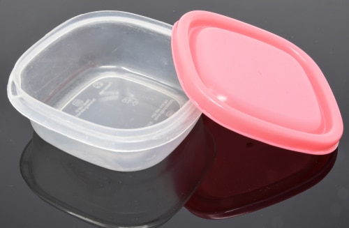 A small Tupperware box with  a pink lid
