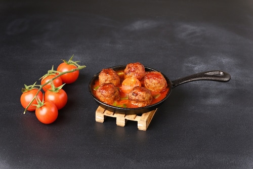 Stewed meatballs in tomato sauce in a pan
