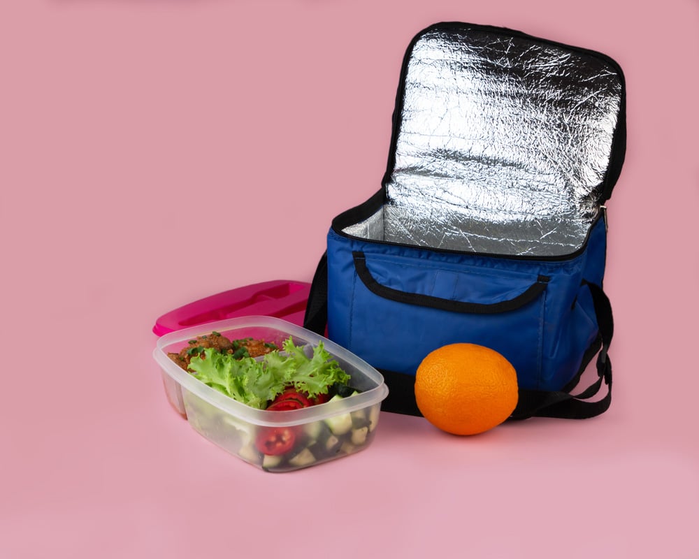 Thermal bag and container with salad, meat and orange