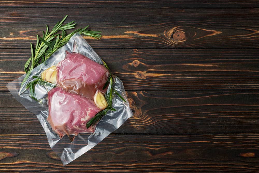 Vacuum-packed meat on a wooden board
