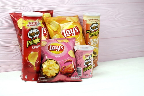 Various flavored of lay's and pringles potato chips in classic packages design