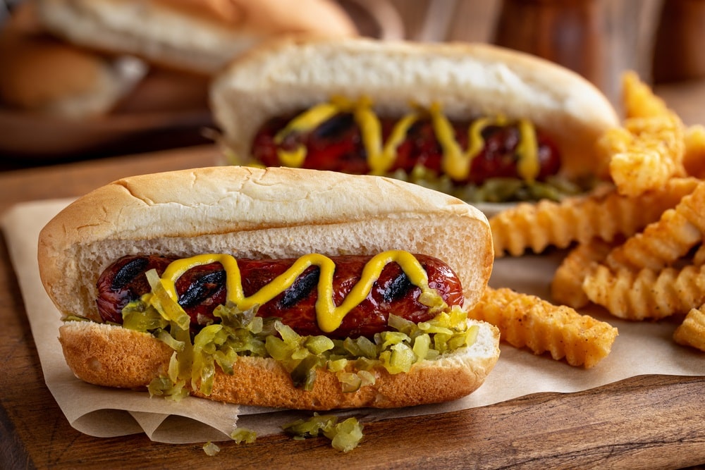Grilled hot dog with mustard and relish