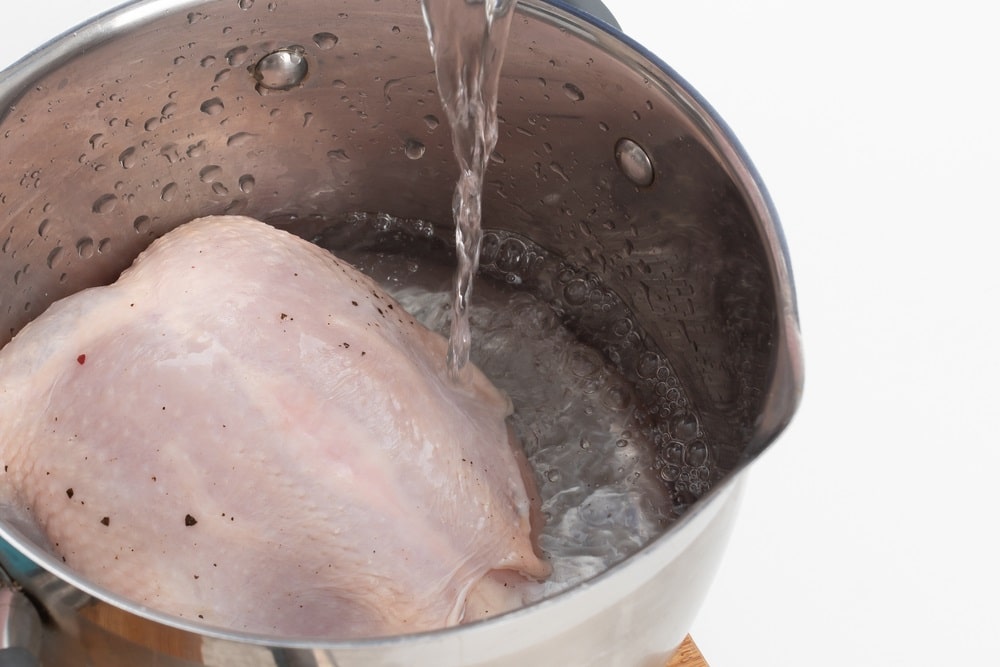 Add water to the chicken breast in a pan
