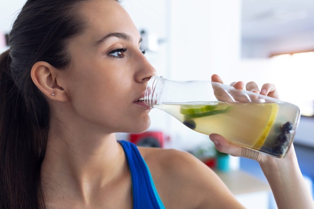 woman drinking detox lemon juice