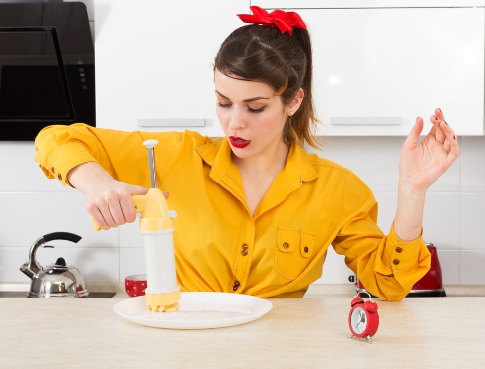 pin up housewife in her kitchen with cookie press