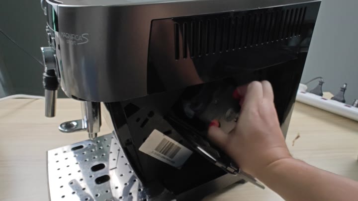 Accessing bottom compartment of espresso machine Accessing bottom compartment of espresso machine