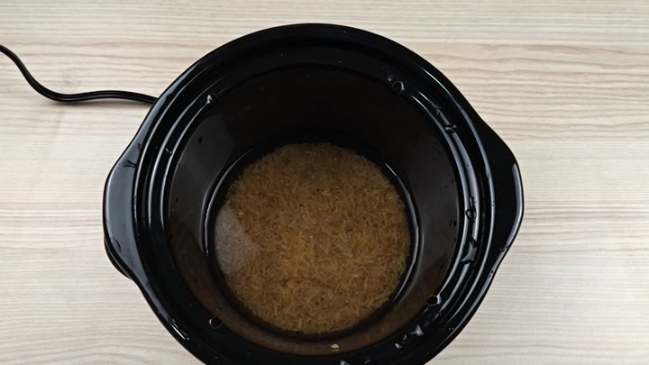 Brown rice and water in pot Brown rice and water in pot