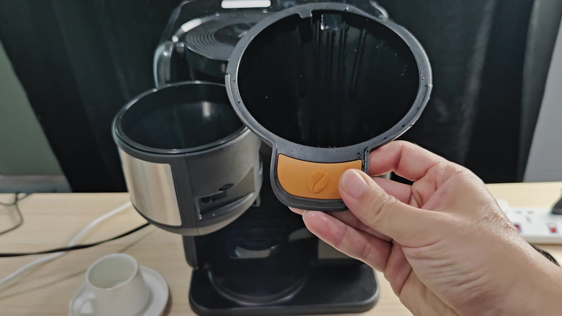 Cone-shaped coffee filter ready for insertion Cone-shaped coffee filter ready for insertion
