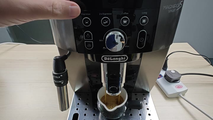 Dispensing espresso into a small cup Dispensing espresso into a small cup