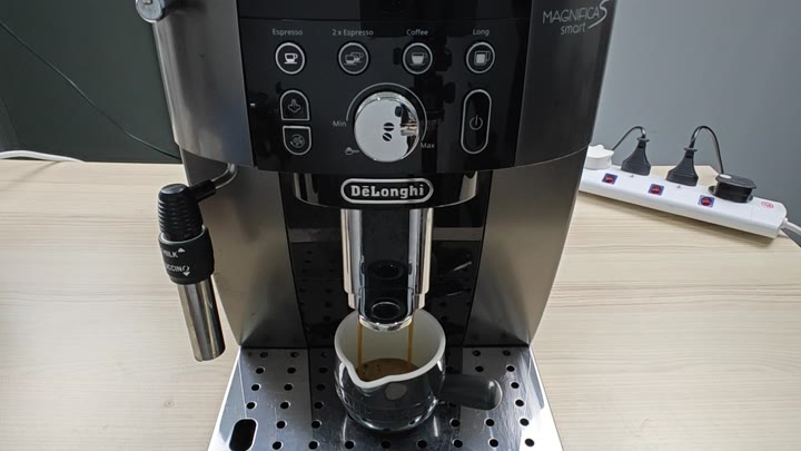 Espresso brewing into black cup Espresso brewing into black cup
