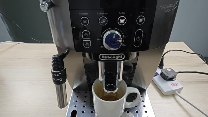 Espresso dispensing with volume dial visible Espresso dispensing with volume dial visible