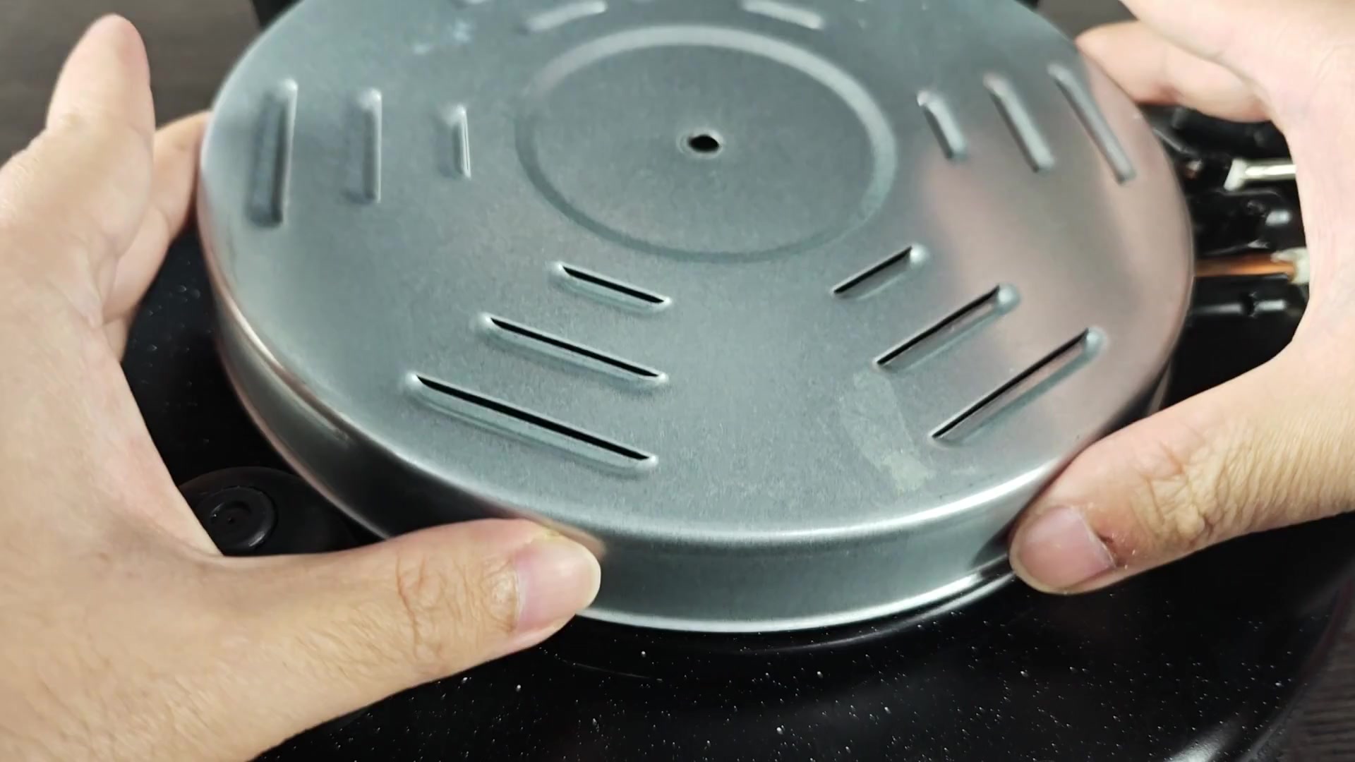 Exposed spiral heating element on black base Exposed spiral heating element on black base