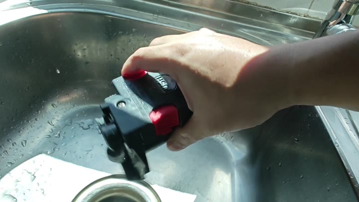 Holding Bosch power tool over sink Holding Bosch power tool over sink