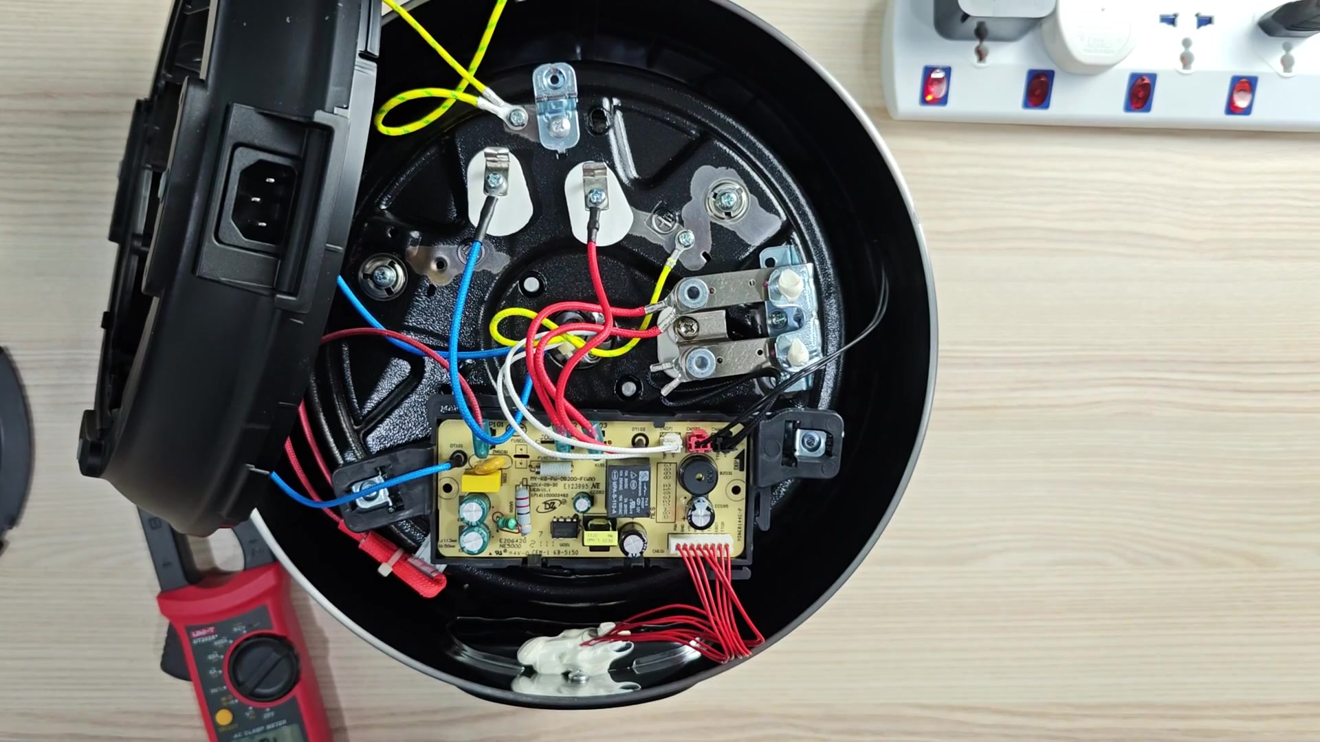 Internal PCB next to white power strip Internal PCB next to white power strip