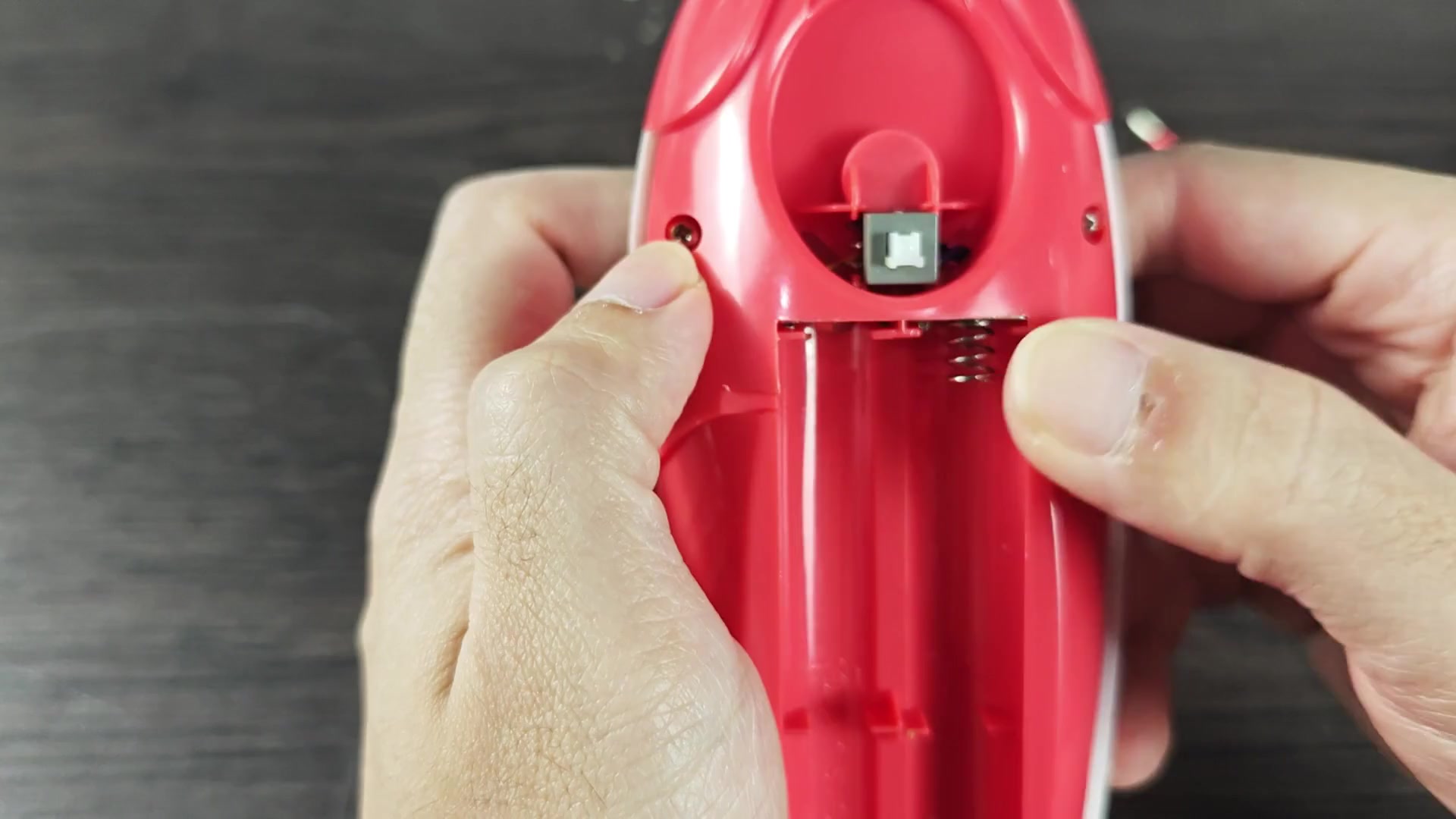 Loosening screw on red device Loosening screw on red device